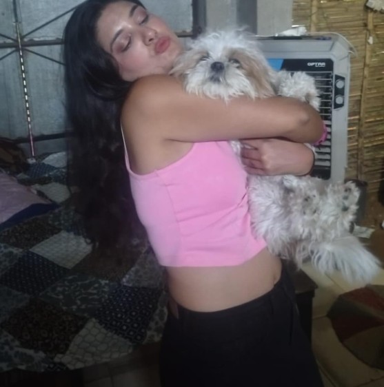 Harshil Kalia posing with her pet dog