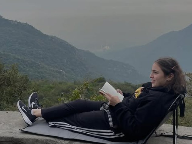 Mahnoor Omer while reading a book during a trip