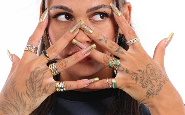 Trinity Rodman's tattoos on the back side of her both hands and fingers