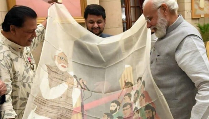Biren Kumar Basak while gifting a shawl to Prime Minister Narendra Modi