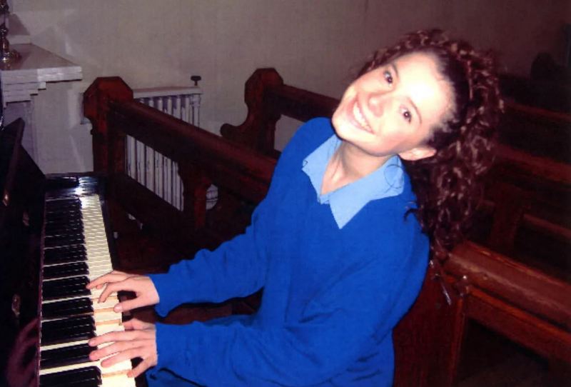 Jessie Buckley playing piano in her youth