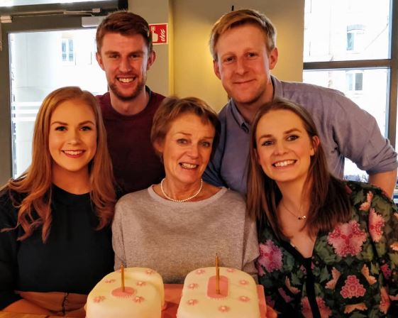 Michael Patrick (standing, right) with his family