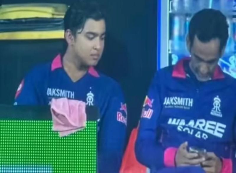 Romi Bhinder using phone at the dugout
