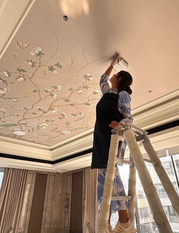 Basuri Chokshi while painting a ceiling