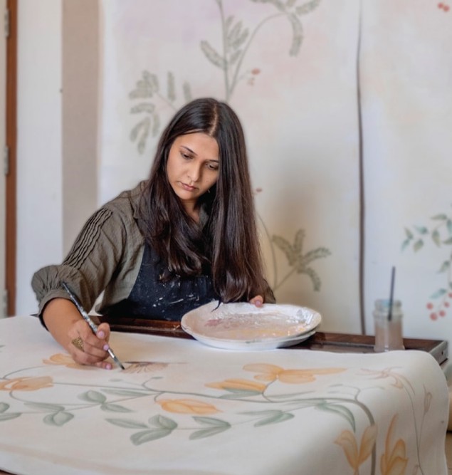 Basuri Chokshi while painting a fabric