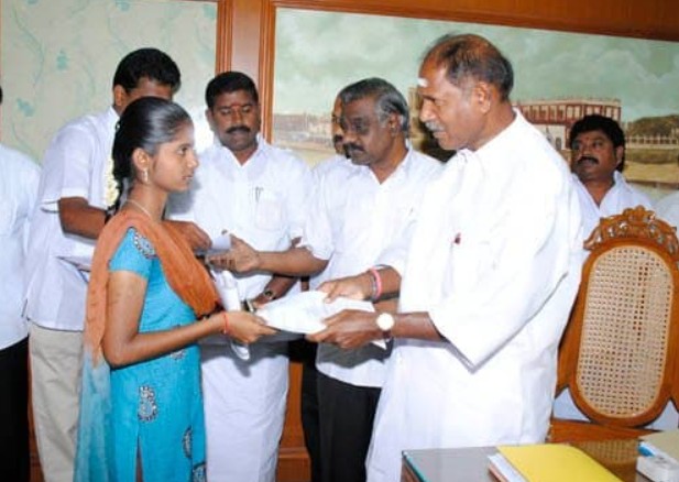 N. Rangaswamy posing with a student