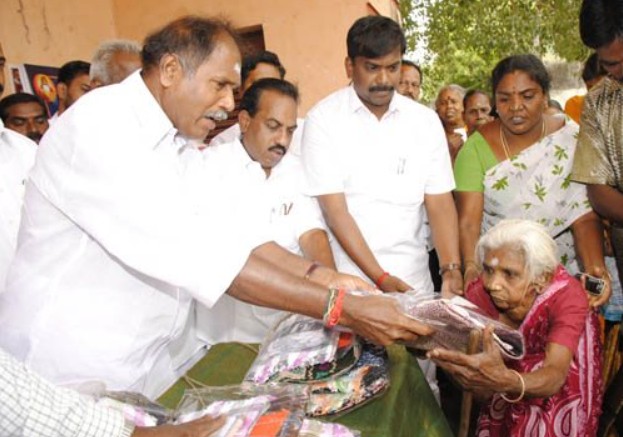 N. Rangaswamy while distributing clothes to poor