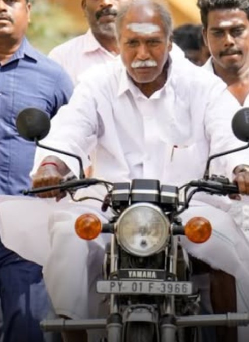 N. Rangaswamy while riding a motorbike