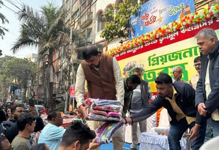 Sujit Bose while distributing clothes to the poor during a political campaign