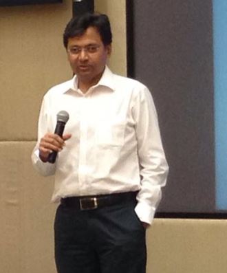 Hital Meswani giving a talk at a corporate event