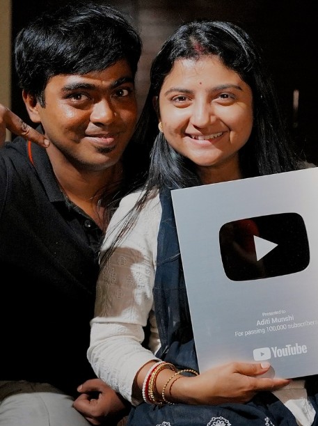 Aditi Munshi posing with her brother and YouTube silver button