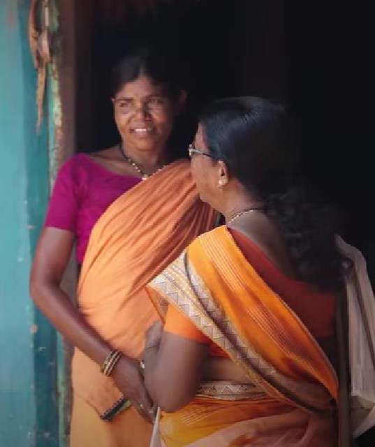 Budhri Tati while talking to a woman