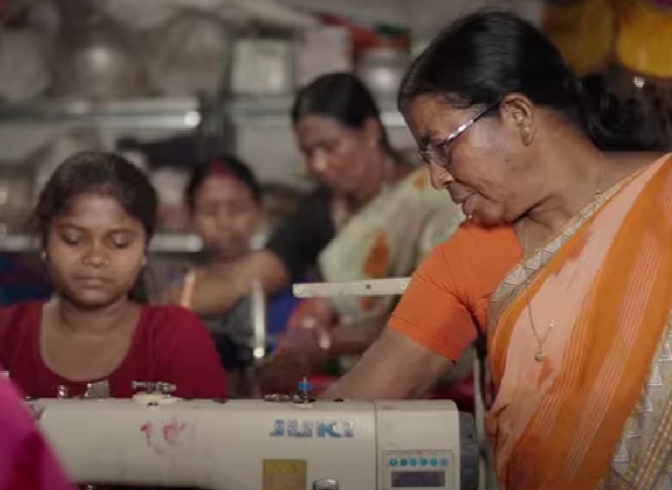 Budhri Tati while teaching stitching to young women