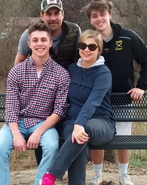 Myles Mantzaris (sitting) with his parents and brother Logan