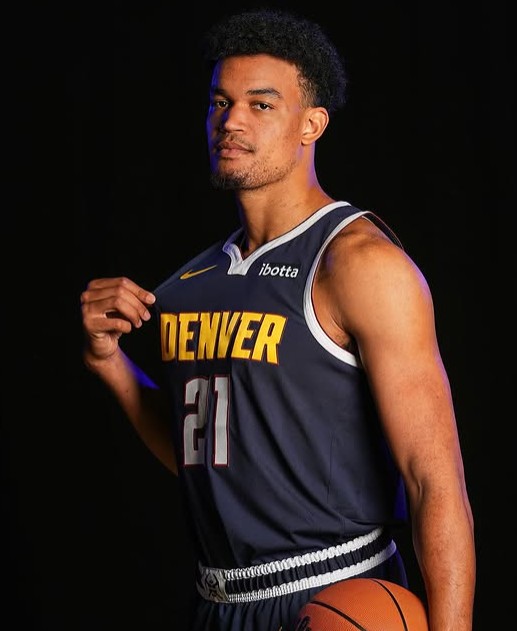 Spencer Jones posing in Denver Nuggets' uniform