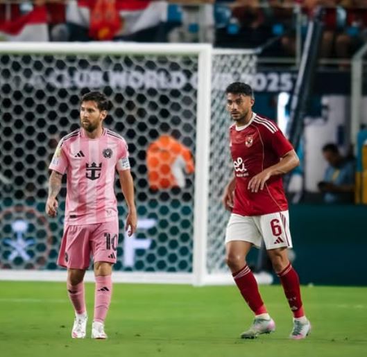 Yasser Ibrahim with Lionel Messi on the ground
