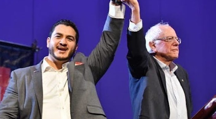 Abdul El-Sayed posing with Bernie Sanders during a political rally