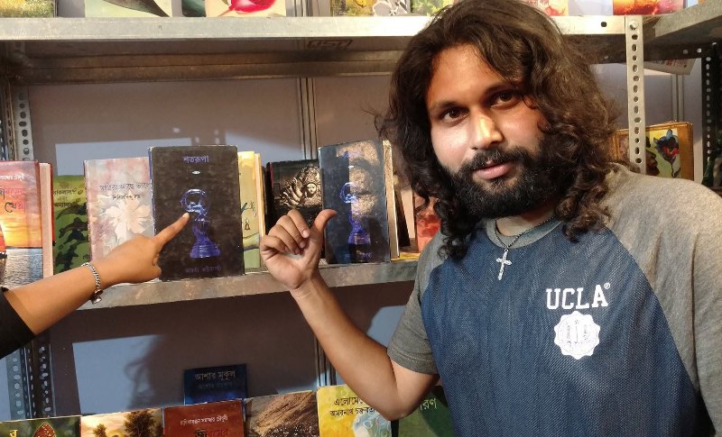 Amartya Bhattacharyya posing with his book 'Shatarupa' (2012)