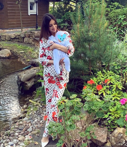 An old picture of Oksana Voevodina posing with her newborn son