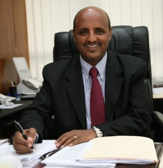 Tewolde Gebremariam posing at his workplace