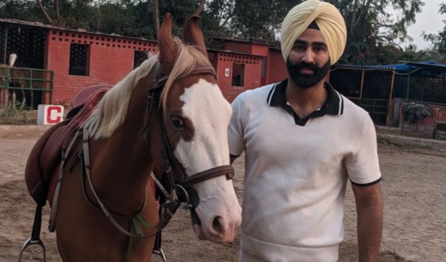 Angad Singh Dhillon posing with a horse
