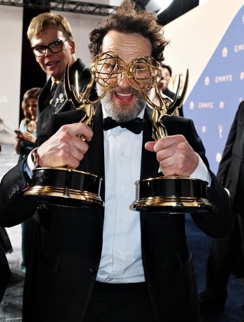 Matthew Rhys posing with his awards
