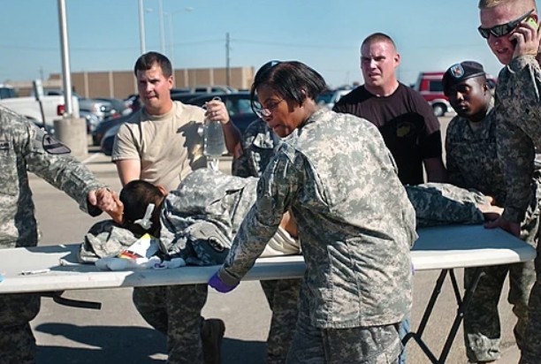 First responders and soldiers transport a fellow soldier wounded in the Fort Hood shooting